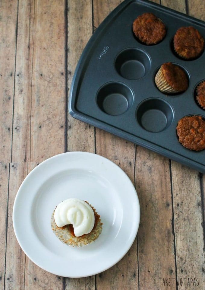 These moist and spicy mini carrot cake cupcakes are the perfect bite with the addition of tart lemon curd and creamy cream cheese frosting! Mini Carrot Cake Cupcakes Recipe with a Surprise | Take Two Tapas