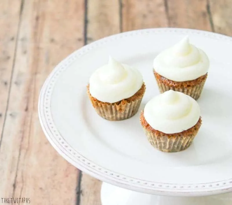 These moist and spicy mini carrot cake cupcakes are the perfect bite with the addition of tart lemon curd and creamy cream cheese frosting! Mini Carrot Cake Cupcakes Recipe with a Surprise | Take Two Tapas