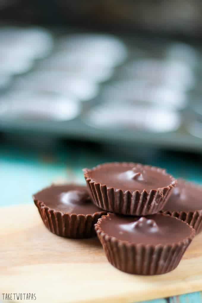 Skip the packaged peanut butter cups in the store and make your own! These peanut butter cups are covered in dark chocolate instead of milk chocolate and have toasted hemp seeds inside for a little crunch. Dark Chocolate Peanut Butter Cups Recipe | Take Two Tapas