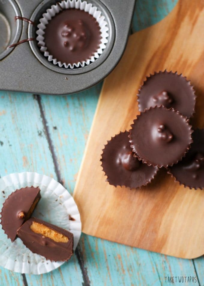 Skip the packaged peanut butter cups in the store and make your own! These peanut butter cups are covered in dark chocolate instead of milk chocolate and have toasted hemp seeds inside for a little crunch. Dark Chocolate Peanut Butter Cups Recipe | Take Two Tapas