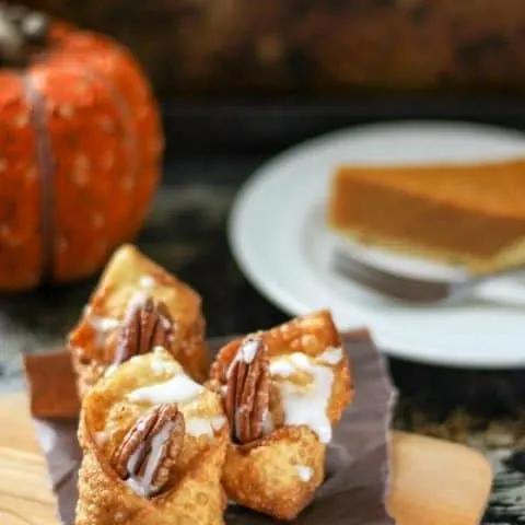 Close up of the chocolate pumpkin wontons on a wood serving board