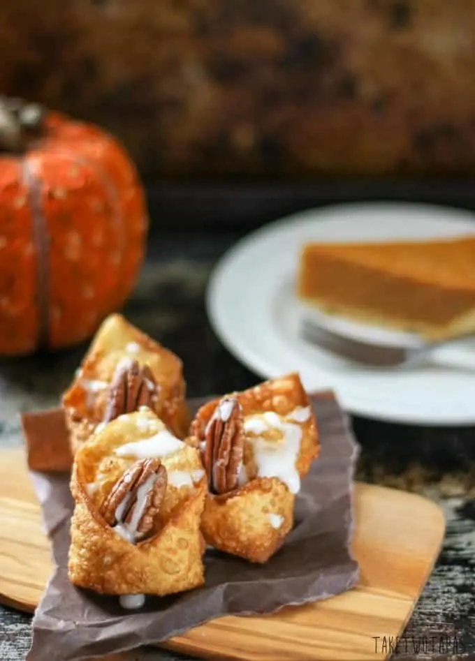 Close up of the chocolate pumpkin wontons on a wood serving board
