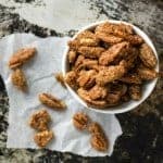 These crispy pecans are coated in brown sugar and the spices of a gingersnap cookie! Ginger, cinnamon, cloves, and a touch of molasses! These gluten-free pecans will make you think you are eating your favorite gingersnap cookies! Gingersnap Pecans Recipe | Take Two Tapas | #GingerSnaps #GingerRecipes #HolidaySnacks #HolidayRecipes