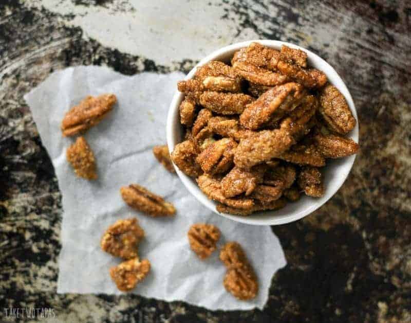 These crispy pecans are coated in brown sugar and the spices of a gingersnap cookie! Ginger, cinnamon, cloves, and a touch of molasses! These gluten-free pecans will make you think you are eating your favorite gingersnap cookies! Gingersnap Pecans Recipe | Take Two Tapas | #GingerSnaps #GingerRecipes #HolidaySnacks #HolidayRecipes