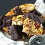 These bite-sized snack bites are filled with nuts and seeds and held together with honey. These are great for those on Paleo or clean eating diets! Gluten free too! Chocolate Dipped Paleo Snack Bars Recipe | Take Two Tapas | #Paleo #Chocolate #Granola #Nuts #Bars #Snacks