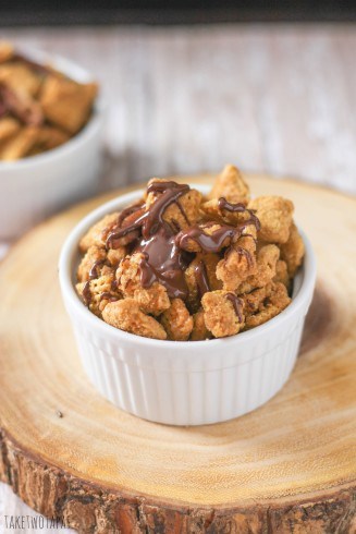 This iconic Chex Mix recipe is made from Rice and Corn Chex and covered in a crunchy caramel coating that contains a dash of cinnamon. This Chex Mix Crack Recipe also has a dark chocolate drizzle on it for another touch of sweetness. | Take Two Tapas