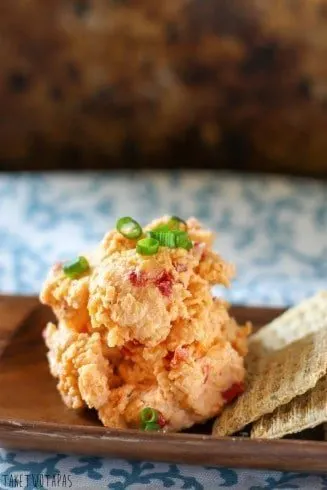 Creamy, cheesy Pimento Cheese Spread is a great party spread! You can make it ahead of time, it keeps for a few days - if it lasts that long, and you can serve it in a bowl or roll it into a cheese ball and sprinkle with toasted pecans! Serve with crackers or on a burger! Pimento Cheese Spread Recipe | Take Two Tapas
