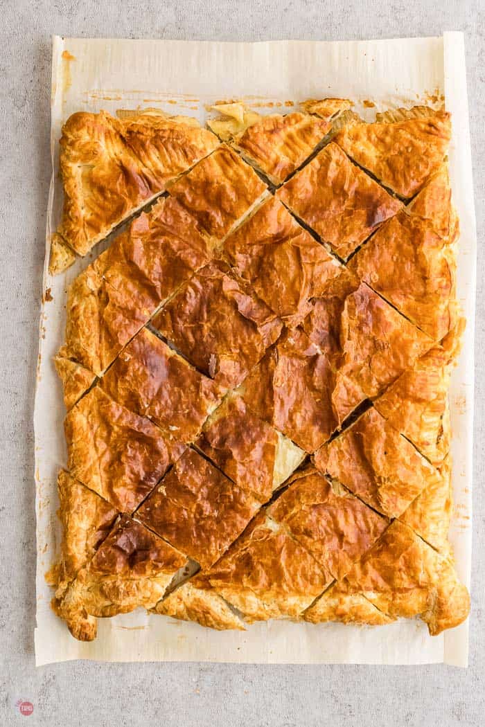 Overhead of Spicy Corned Beef Creamy Swiss Cheese puff pastry sliders on a cutting board