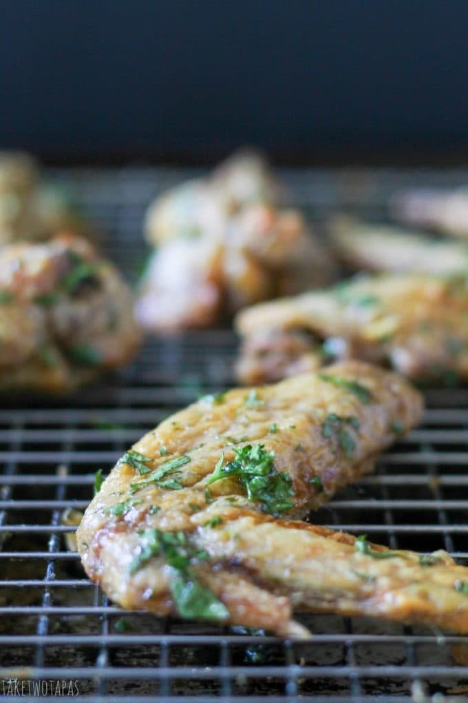 Close up of a Green herb chicken wing on a baking rack