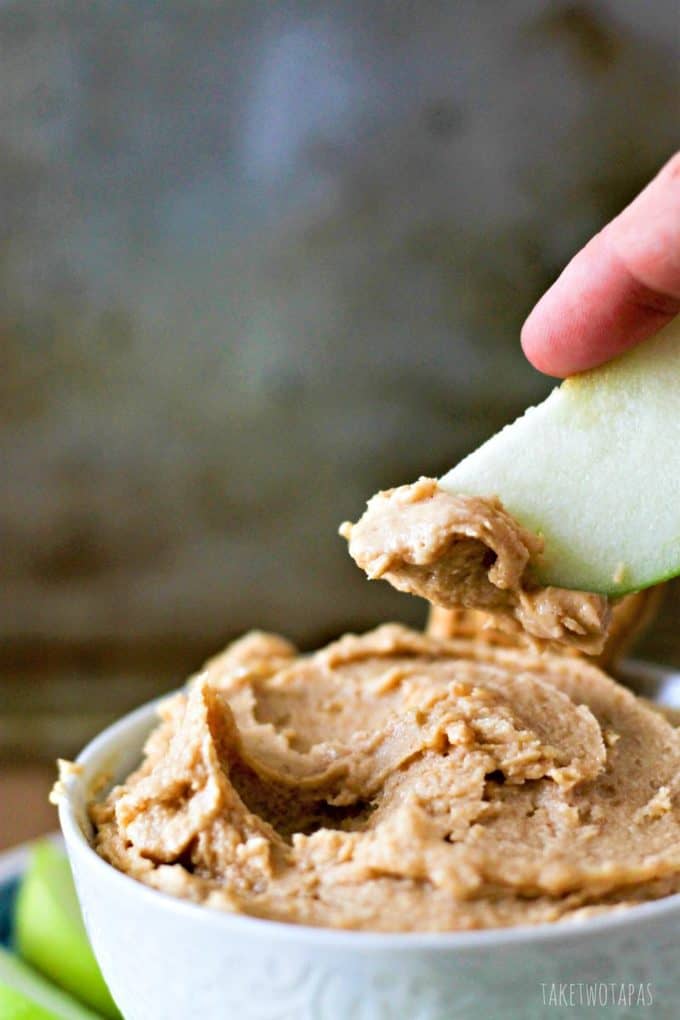 Nutter Butter dip with a hand dipping an apple in it