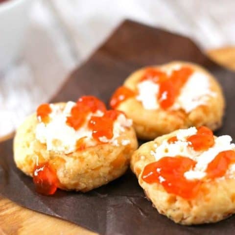 close up spicy cheese thumbprints on a cutting board