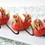 Want a fun twist on an antipasto salad? Try these Hasselback Antipasto Tomatoes! All the delicious ingredients of an antipasto salad all tucked into a tomato. Antipasto Hasselback Tomatoes Recipe | Take Two Tapas | #Hasselback #Tomatoes #Healthy #Antipasto #Salad