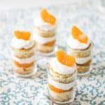You may have had a Pig Lickin' cake or a mandarin orange cake, but these small dessert shooters are a deconstructed version of that classic. Fluffy cake, pineapple whip cream, and mandarin orange segments make a great dessert for Summer. Sunrise Orange Shooters Recipe | Take Two Tapas | #Pigpickincake #Orange #MandarinOranges #SunshineCake #PigLickinCake #CakeRecipe #PigPickinCakeRecipe