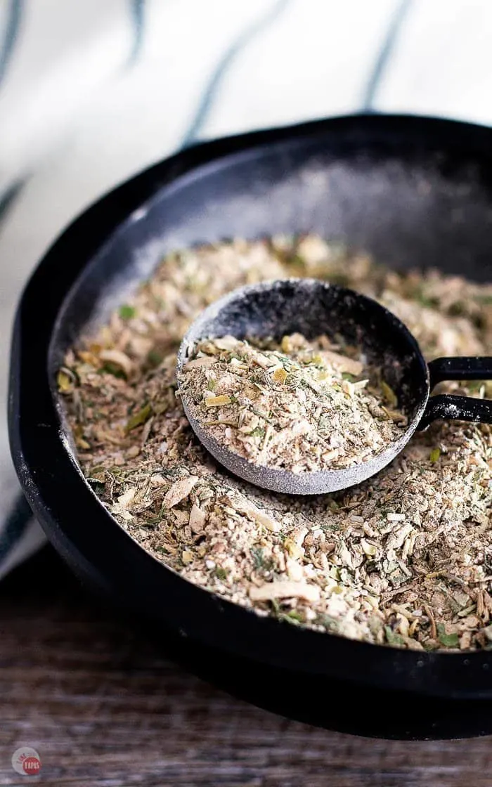 greek seasoning in a bowl with a measuring spoon
