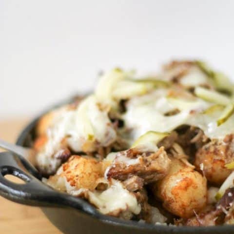 Side view of Cuban Totchos nachos in a cast iron pan