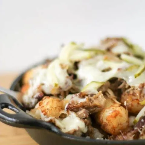 Side view of Cuban Totchos nachos in a cast iron pan