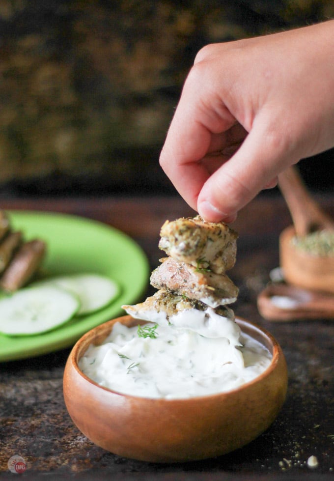 Greek Chicken Nuggets being dipped in the tzatziki sauce