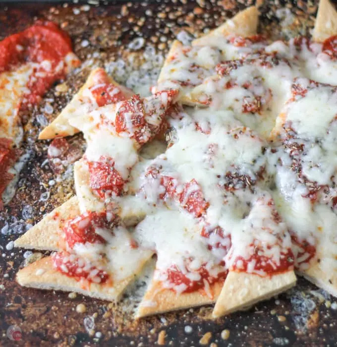 overhead of pizza nachos on a sheet pan