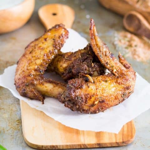 Close up of Jerk seasoned chicken wings on a cutting board