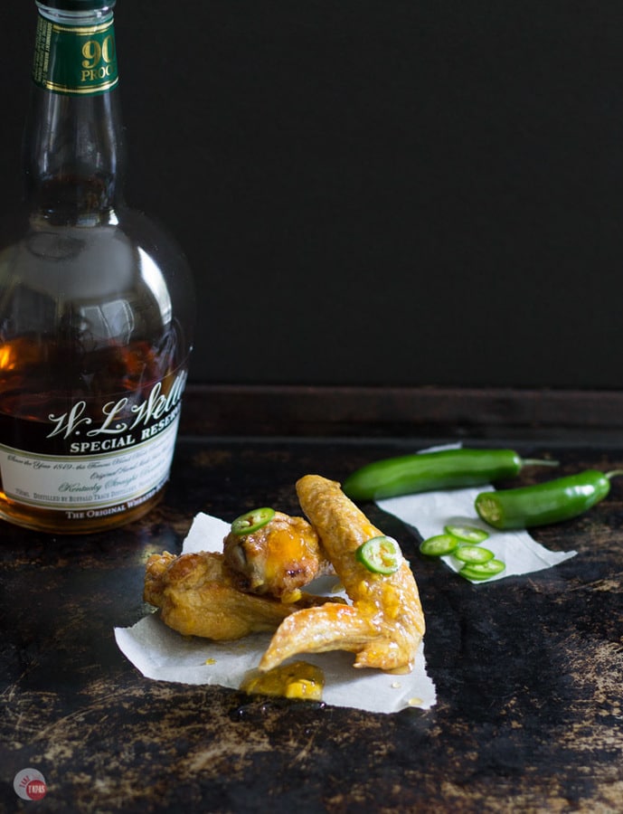 Sweet and Spicy Chicken Wings are even better with fresh peaches and a hint of boozy bourbon! Peach Bourbon Sweet and Spicy Chicken Wings Recipe | Take Two Tapas | #Peach #Bourbon #ChickenWings #ChickenWingFlavors #ChickenWingSauces #Spicy