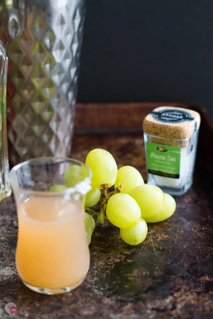 Green Grape Salty Dog Cocktail Shot and green grapes on a wood table