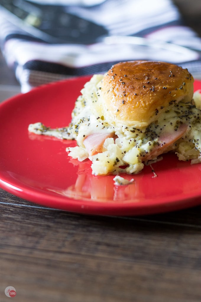A Hawaiian pizza slider on a red plate