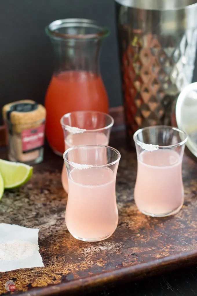 Paloma pink grapefruit shots on a wood table