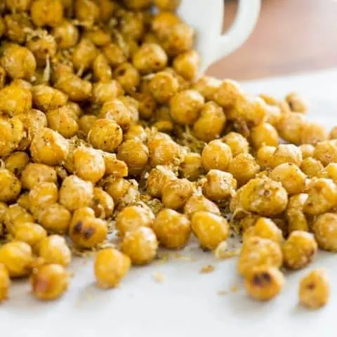 Close up of Pan Roasted Chickpeas spilling on parchment paper