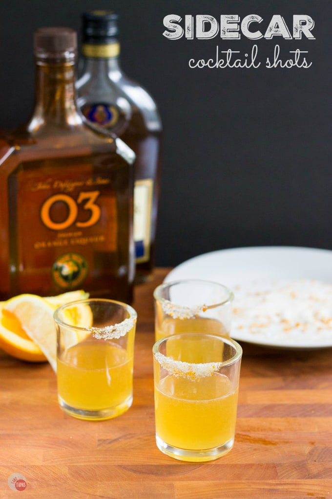 The Sidecar is a cocktail that combines cognac, orange liqueur, and lemon juice for a sophisticated drink. Try this classic cocktail in a smaller version with a sugared rim! Sidecar Cocktail Shot Recipe | Take Two Tapas | #SidecarCocktail #Cognac #CocktailRecipe #CocktailShots #SidecarShot #OrangeLiqueur #PartyDrinks