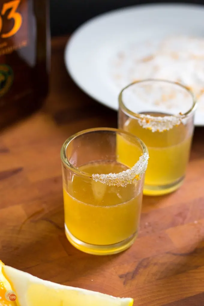 The Sidecar is a cocktail that combines cognac, orange liqueur, and lemon juice for a sophisticated drink. Sidecar Cocktail Shot Recipe | Take Two Tapas | #SidecarCocktail #Cognac #CocktailRecipe #CocktailShots #SidecarShot #OrangeLiqueur #PartyDrinks
