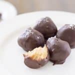 Buttery and flaky crackers are mixed with creamy peanut butter and sweet honey and rolled into tiny truffles. Dipped in dark chocolate and dusted with flake salt and they are the perfect bite! Salted Cracker Truffles with Peanut Butter and Honey Recipe | Take Two Tapas