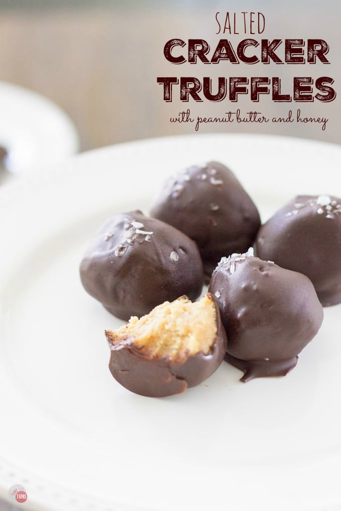Buttery and flaky crackers are mixed with creamy peanut butter and sweet honey and rolled into tiny truffles. Dipped in dark chocolate and dusted with flake salt and they are the perfect bite! Salted Cracker Truffles with Peanut Butter and Honey Recipe | Take Two Tapas | #TruffleRecipe #truffles #Crackers #PeanutButter #Honey