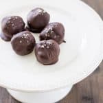 Buttery and flaky crackers are mixed with creamy peanut butter and sweet honey and rolled into tiny truffles. Dipped in dark chocolate and dusted with flake salt and they are the perfect bite! Salted Cracker Truffles with Peanut Butter and Honey Recipe | Take Two Tapas
