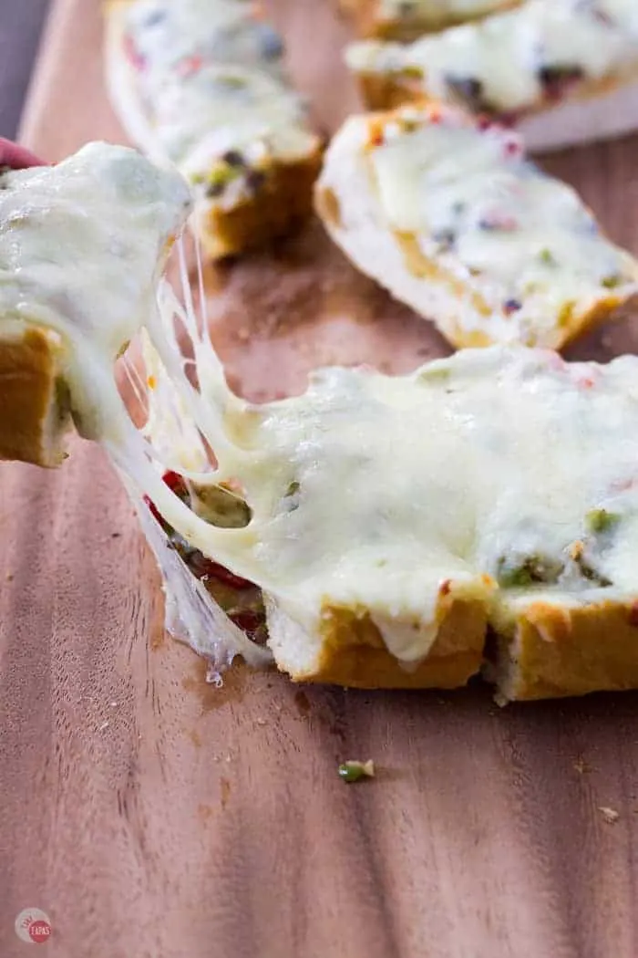 Pulling the cheesy olive bread apart