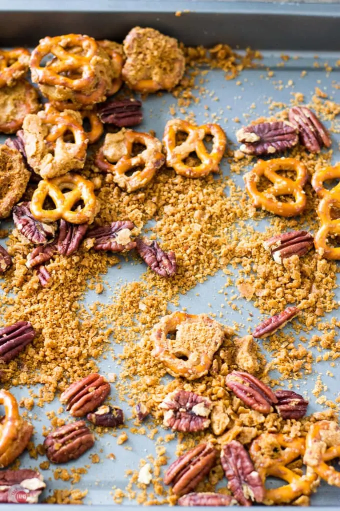 Step up your snack game with pretzels and pecans covered in a crispy caramel coating that is addicting! Crispy Caramel Crack Pretzels Recipe | Take Two Tapas | #CrackPretzels #ToffeePretzels #PretzelCandy