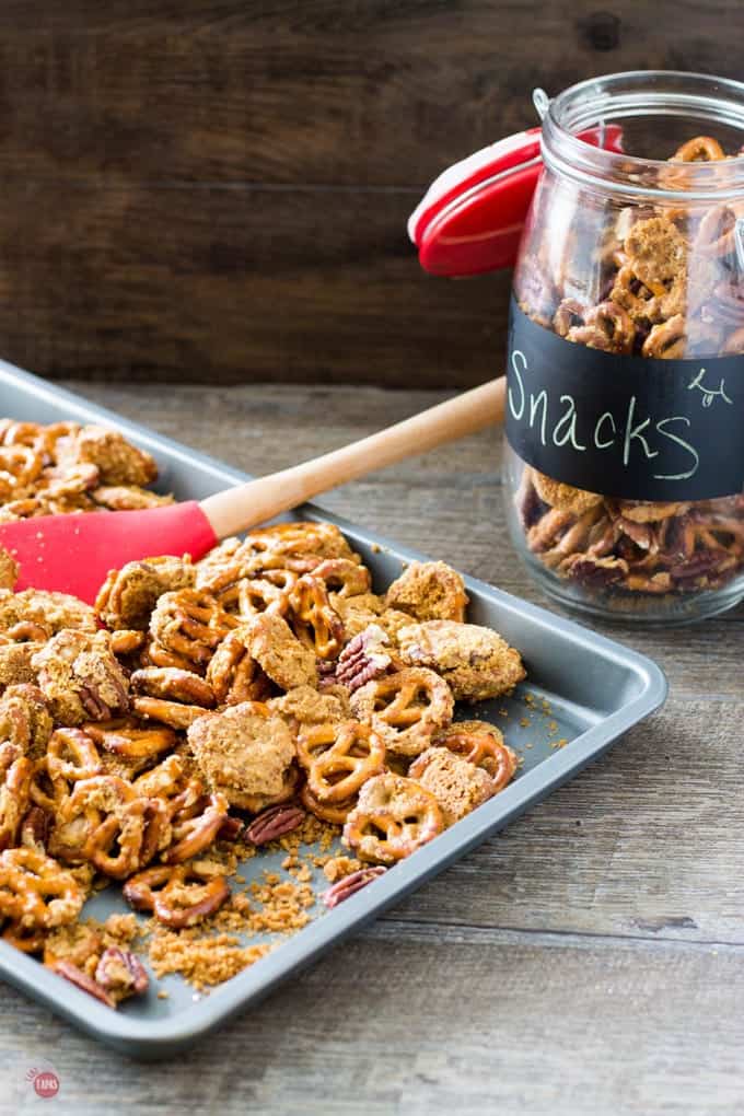 Crack Pretzels with Crispy Caramel and Pecans on a sheet pan and in a jar