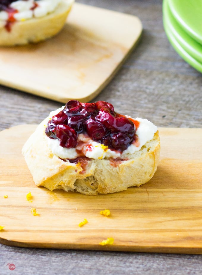 close up of Roasted Cranberry Ricotta Crostini on a cutting board