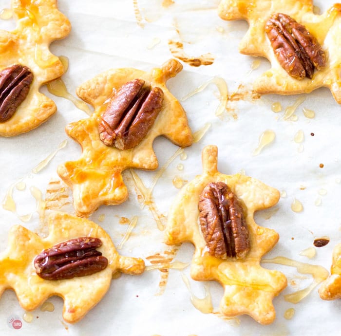 Overhead of Pie crust cookies with whiskey caramel drizzle on parchment paper