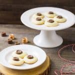 The sweetness of a shortbread thumbprint cookie is matched with a caramel Rolo candy and dusted with sea salt! Meet your new favorite cookie exchange member! Salted Rolo Thumbprint Cookie Recipe | Take Two Tapas | #RoloCandy #ThumbprintCookies #CookieRecipe #Salted #Chocolate #Caramel #CookieExchangeRecipe