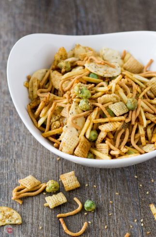 Snack mix takes a trip around the globe and lands in Asian! My Asian Wasabi Chex Mix is loaded with sesame seeds, rice crackers, crunchy chow mein noodles, crispy wasabi peas, and coated with a soy wasabi sauce! Get ready to be addicted to the Far East! Asian Wasabi Chex Mix Recipe | Take Two Tapas