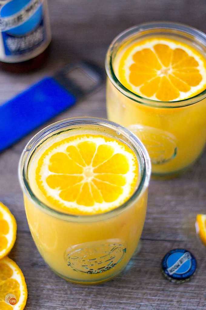 orange shandy in two glasses