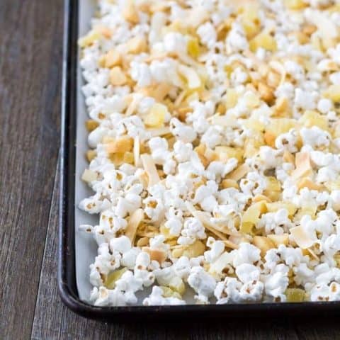 Popcorn mixture spread out on a sheet pan.