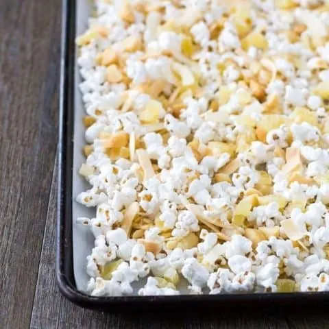 Popcorn mixture spread out on a sheet pan.