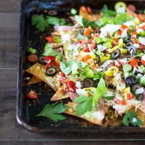 Italian sheet pan nachos on a wood surface