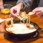 Slow simmered arrabbiata sauce mixed with sausage and veggies and topped with cheese makes the perfect dip to share with friends! Arrabbiata Skillet Sausage Dip with Pizza Chips Recipe | Take Two Tapas