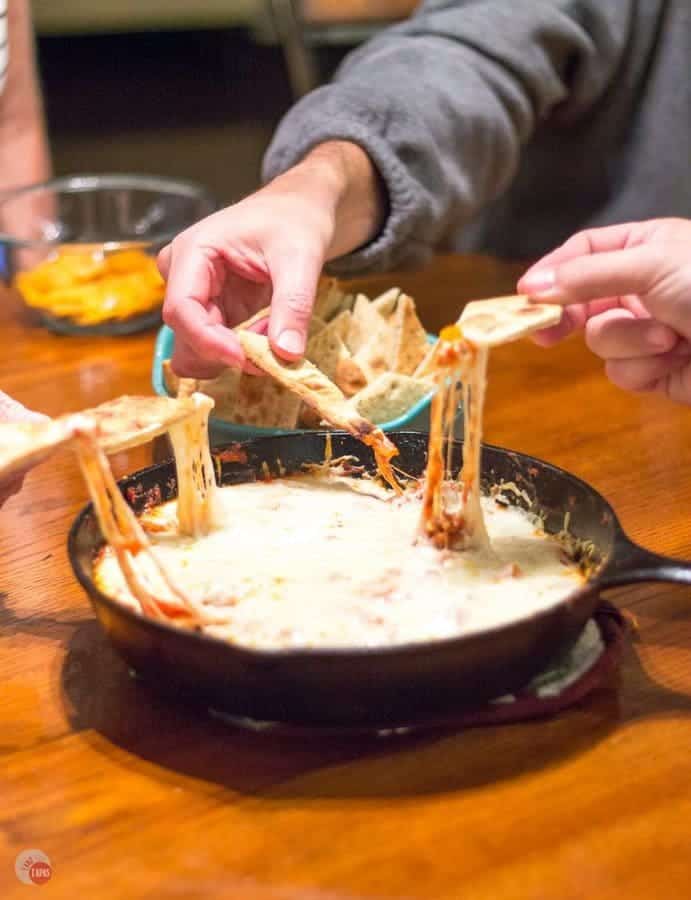 Slow simmered arrabbiata sauce mixed with sausage and veggies and topped with cheese makes the perfect dip to share with friends! Arrabbiata Skillet Sausage Dip with Pizza Chips Recipe | Take Two Tapas