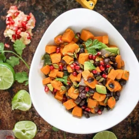 Overhead of Sweet potatoes, black beans, and avocado in a white bowl