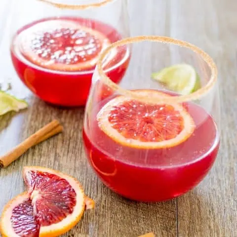 Blood Orange and Cinnamon Margarita's on a wood surface