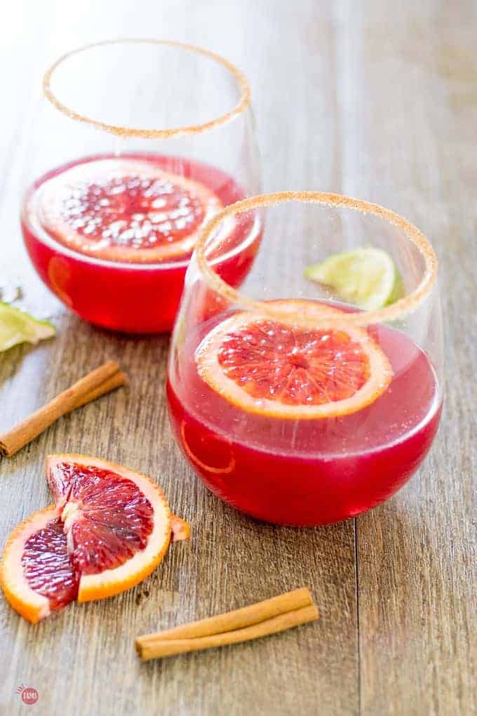 Blood Orange and Cinnamon Margarita's on a wood surface