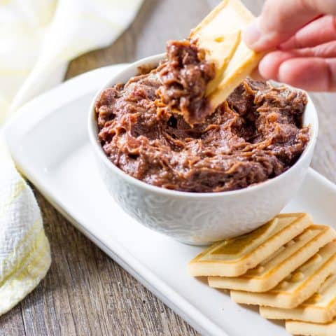Dipping a cookie in to the Kentucky Derby Pie Dip with Pecans